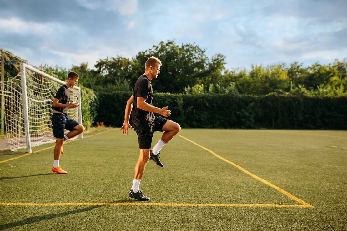 Zwei Männer trainieren auf einem Fußballplatz